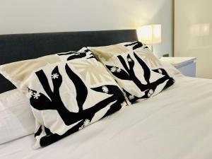 a bed with a black and white blanket on it at Berkeley House in Eastbourne