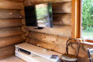 TV a parete con scrivania e sedia di La Tzarma a Granges