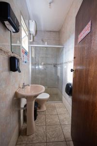 a bathroom with a sink and a toilet and a shower at Pousada Zacarias in Ouro Preto +72 photos