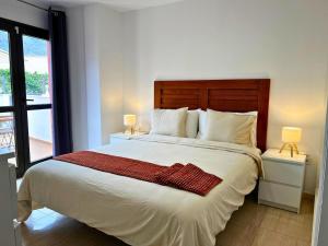 a bedroom with a large white bed with two lamps at Rincón cálido in Adeje