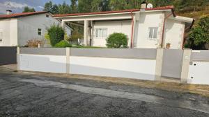 a white fence in front of a house at Lar do Sossego in Geme