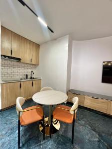 a kitchen with a table and chairs in a room at Xplora in Abuja
