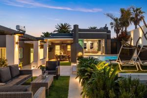 a house with a swimming pool and a patio at Rancho Relaxo by Host Agents in Bloubergstrand