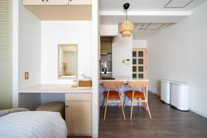 a bedroom with a bed and a table and two chairs at ダイナスティパレス58 in Sapporo +217 photos