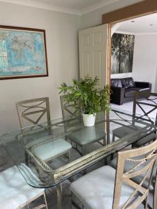 a glass table and chairs in a living room at JustB Edinburgh in Edinburgh