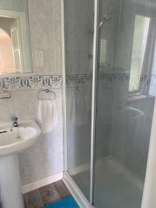a bathroom with a shower and a sink at JustB Edinburgh in Edinburgh