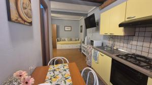 a kitchen with a table and a dining room at Apartment Trezza in Acitrezza