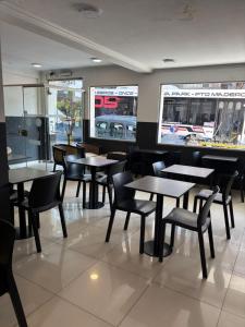 a dining room with tables and chairs in a restaurant at Aires Express in Buenos Aires +7 photos