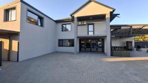 a large white house with a driveway at Casa Medeea in Podu Turcului