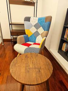 a chair and a coffee table in a living room at Like at Home Trastevere in Rome