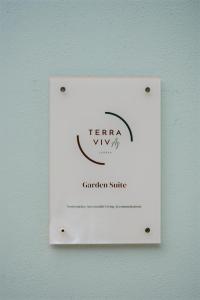 a white lightswitch on a wall with the words terra viva member suite at Terra Vivaz - Ribeira Cottage in Ribeira Grande