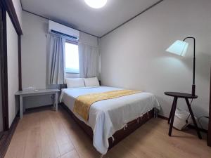 Ένα ή περισσότερα κρεβάτια σε δωμάτιο στο 遇見民宿