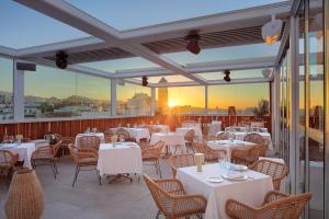 a restaurant with tables and chairs on a balcony at Óbal Hotel Marbella in Marbella