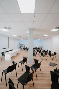 an empty room with chairs and a white wall at Eden Hotel in San Salvo
