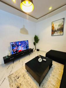 a living room with a large flat screen tv at Résidence Océane in Godomey