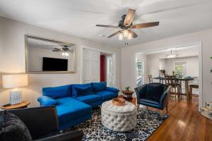 a living room with a blue couch and a table at Cozy 4BR Home Pet Friendly Large Yard & Patio in Hattiesburg