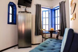 a living room with a blue couch and a table at Pousada Maikai Garden in Porto Belo