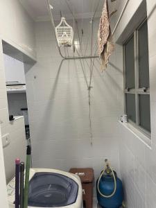 a bathroom with a blue toilet in a room at Enseada apartment accommodates up to 8 people in Guarujá