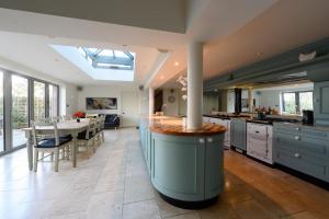 a kitchen with a large island in the middle at Vine Cottage in Blakeney