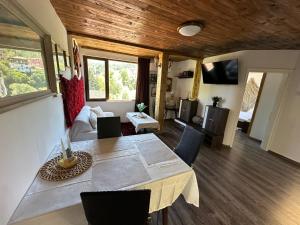 a room with a dining table and a living room at Mountain Whisper Guesthouse in Smolyan