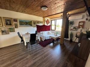 a living room with a table and a couch at Mountain Whisper Guesthouse in Smolyan