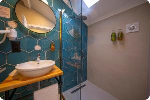 a bathroom with a sink and a mirror at Hotel Zon in Serdivan +35 photos