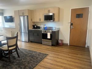 a kitchen with stainless steel appliances and wooden cabinets at Residences at Solomon Pond in Marlborough +2 photos