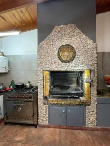 a kitchen with a stone oven in a kitchen at Departamento in Necochea