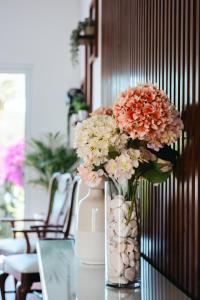 a vase filled with flowers sitting on a table at Terra Vivaz - Ribeira Cottage in Ribeira Grande