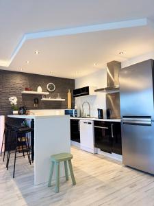 a kitchen with stainless steel appliances and a counter at LA PROVENCE- 75m2 of Light & Charm, Modern Family apartment, Pool & private Parking near Avignon, Fully renovated with interior-architect design in Le Pontet