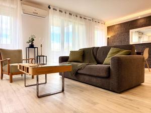 ein Wohnzimmer mit Sofa und Tisch in der Unterkunft LA PROVENCE- 75m2 of Light & Charm, Modern Family apartment, Pool & private Parking near Avignon, Fully renovated with interior-architect design in Le Pontet + 30 Fotos