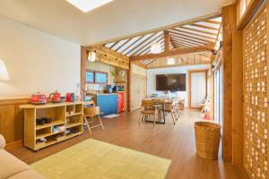 a living room with a kitchen and a dining room at Andong Hanok Stay Traditonal House 안동별장 