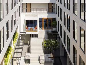 an aerial view of a building with a stairway between two buildings at Novotel Chiangmai Nimman Journeyhub in Chiang Mai