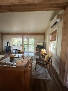 a living room with a couch and a table at Lakeside Cabin - Serene Retreat with Lake Monroe Views and Wraparound Deck in Brown County in Nashville