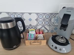 a coffee maker and a blender and a box of cookies at L Escale Esnandaise in Esnandes