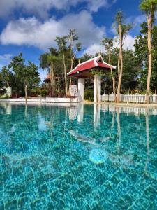 a pool at a resort with a gazebo at Greenhouse Retreat in Senmonorom