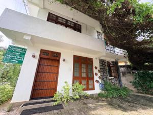 a building with two doors and a sign on it at Metro Stay in Kurunegala