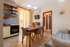 a kitchen and dining room with a table and chairs at Appartamento Vacanza Gliaca in Piraino +18 photos