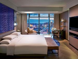 a bedroom with a large bed and a large window at Sofitel Beijing Central in Beijing +94 photos