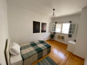 a small bedroom with a bed and a window at Villa Maadi 35 -R302- Double Room in Cairo +19 photos