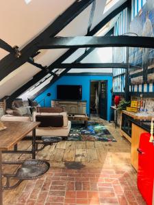 a living room with a couch and a tv at La Petite Maison in Honfleur
