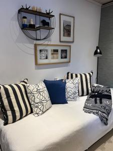 a white couch with pillows in a living room at Casa Hylle in Löddeköpinge