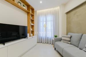 a living room with a large flat screen tv at Zennova #72 Tsinari Comfort & Luxury Suite in Thessaloniki