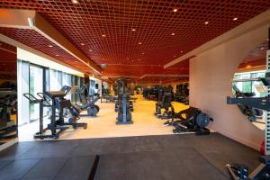 a gym with treadmills and machines in a building at Luxury Pipera 3Rooms Apartament in Voluntari