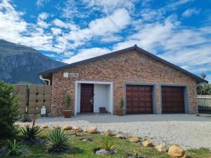 a brick building with two garage doors on it at Heaven Scent in Bettyʼs Bay