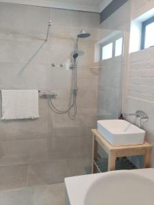 a bathroom with a shower and a sink at Heaven Scent in Bettyʼs Bay