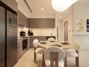 a kitchen with a table and chairs in a room at Grande Signature Residences by Prestige Nest in Dubai