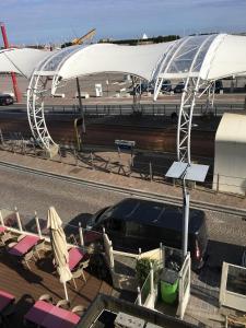 
a train is parked on the tracks at an airport at B&B Le Grand Cabaret in Nieuwpoort
