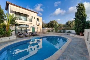 a swimming pool in front of a villa at Villa Dafni with Private Pool in Gouves