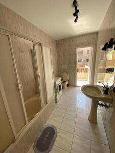 a bathroom with a sink and a shower and a toilet at Villa Maadi 35 -R 303 -Double Room in Cairo